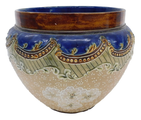 A Doulton Lambeth planter, with a brown and blue treacle glazed rim, with relief moulded decoration with dot and flowers, stamped to underside, 20cm high.