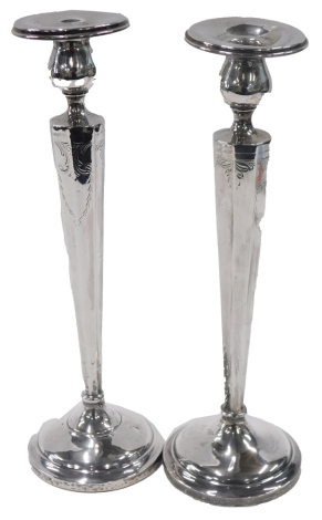 A pair of George V candlesticks, each on a fluted octagonal embossed stem, on a weighted base, Birmingham 1985, 30cm high. (AF)