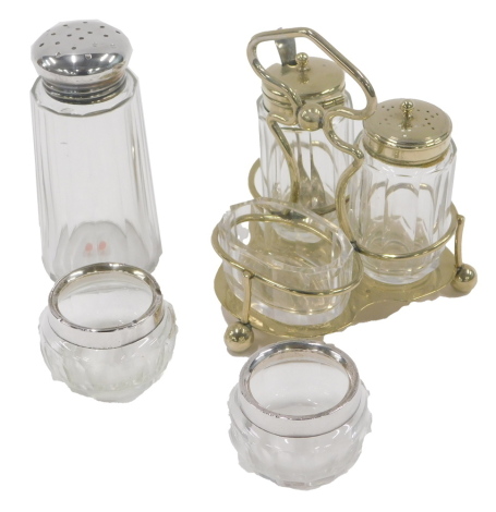 A dressing table set, comprising three piece cruet, with silver plated rims, a pair of silver rimmed salts and a silver topped shaker. (a quantity)