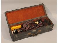 A cased set of bagpipes with reeds.