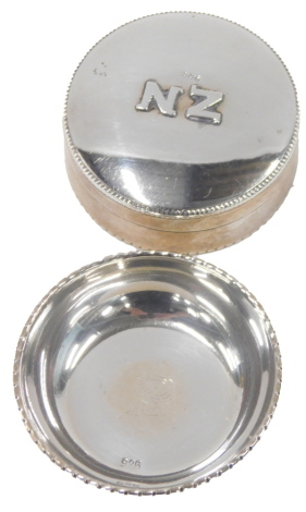 Two items of white metal, comprising a pill box, with beaded border, bearing the initials NZ, white metal stamped 900, and a pin bowl, stamped 925, bearing the initials FB, 1.24oz. (2)