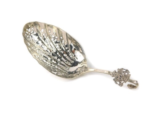 A Dutch white metal sifter spoon, with arched hook top and applied crest, on a pierced floral bowl, with rubbed marks, 1.28oz.