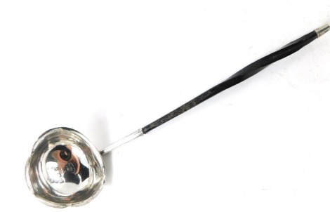 A Georgian style toddy ladle, with twisted ebony handle, on a shaped bowl, hallmarks rubbed, 16cm long.