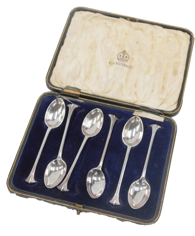 A cased set of six George V silver teaspoons, each with an art deco fanned top, on a plain bowl by Elkington and Co, Birmingham 1921, 3.32oz, cased.