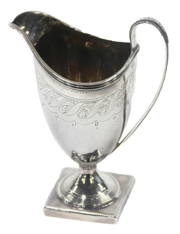 A George IV silver cream jug, the fluted and pierced spout and shaped handle, with engine turned floral decoration, on a square foot, by Peter and Anne Bateman, London 1820.