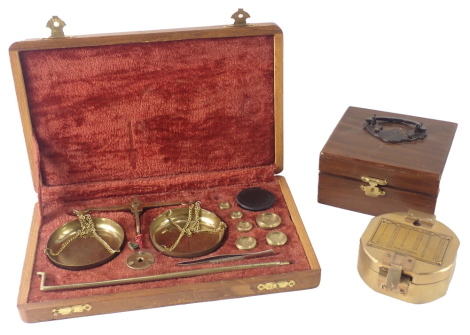 A brass pocket compass, in brass case with hardwood carry box and a pair of scales. (2)