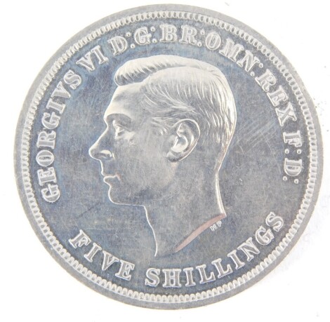 A George VI five shilling coin, dated 1951.