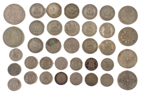 A group of pre-1946 silver coins, shillings, half shillings, florins, etc., 196.5g all in.