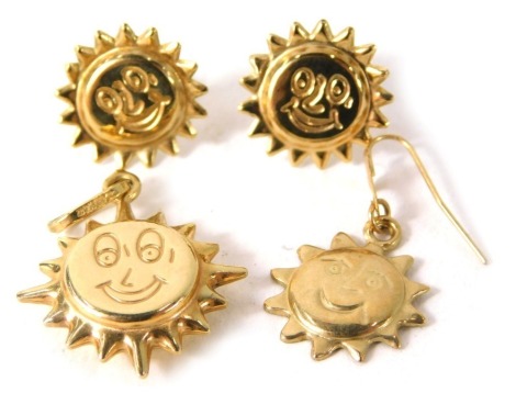 A 9ct gold sun jewellery set, comprising one single drop earrings, pair of studs, and a pendant, each formed as a sun with face, 2.7g all in.