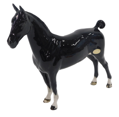 A Beswick black glazed CH Black Magic horse, bearing label.