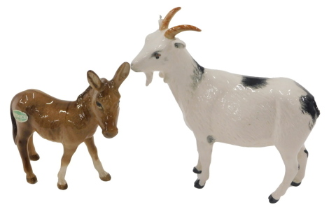 A Beswick donkey, and a Royal Doulton goat.