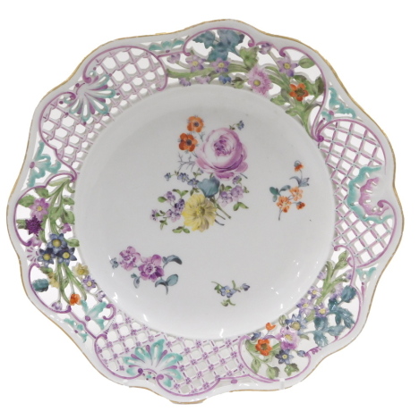 A 19thC Dresden cabinet plate, with a pierced and fret border, with gilt rim and painted turquoise and purple flower outer skin, with cross sword mark to underside, 25cm diameter.