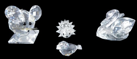 Crystal wares, comprising a Swarovski crystal swan and hedgehog, mouse and bird, with four unmatched boxes.