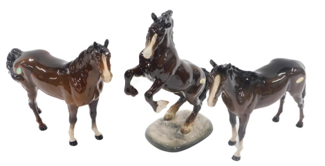 A Beswick brown rearing horse, on circular base stamped Beswick and numbered 1014, and two Beswick brown horses, 2cm high. (3)