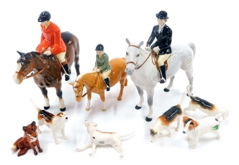 A Beswick hunting group, comprising hunting dogs, a Beswick terrier, fox, lady and gent huntsman, and a child on tan horse. (a quantity, AF)