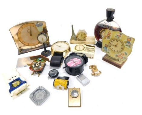 A quantity of novelty clocks and timepieces, to include a racing car, a Garnier scent bottle, Rolling Stols owl, an oversized wristwatch stamped Town Craft, etc.