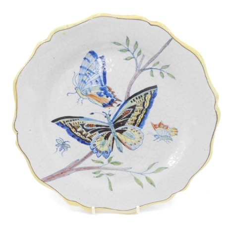 A late 19thC Faience botanical plate, decorated with butterflies, 26cm diameter.