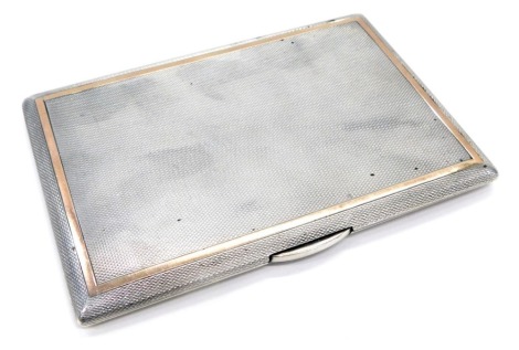 A George VI silver cigarette case, yellow gold banded engine turn design, with gilt interior, London 1950, 7oz all in.