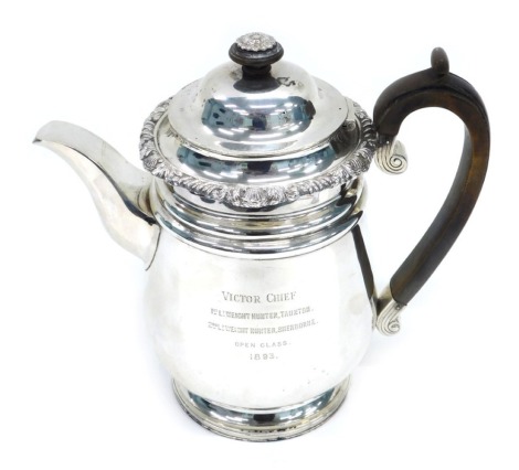 A Victorian silver teapot, with floral engraved rim, crested scroll wooden handle, London 1893, 32oz all in, 23cm high.