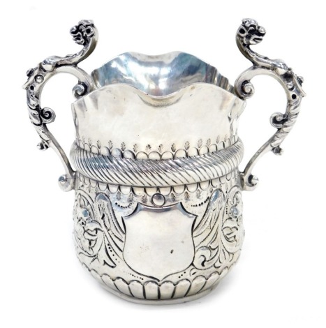 A Victorian silver jug, with double spout, cast scroll handles, engraved decoration, London 1887, 5oz.