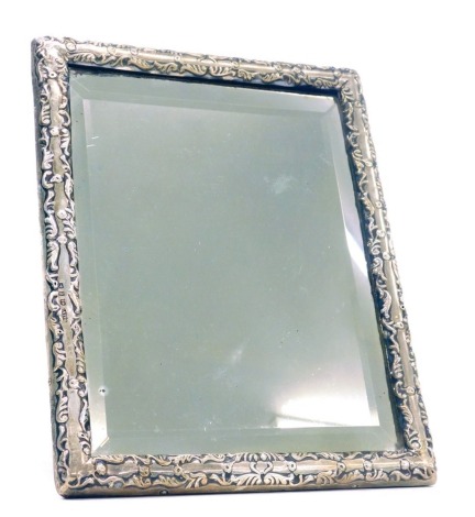 A Victorian silver mounted embossed decorated bevelled edge easel mirror, Birmingham 1900, 27.5cm x 18cm.