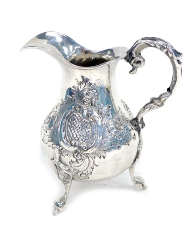 A George V silver milk jug, with embossed floral decoration, Birmingham 1933, 4oz.