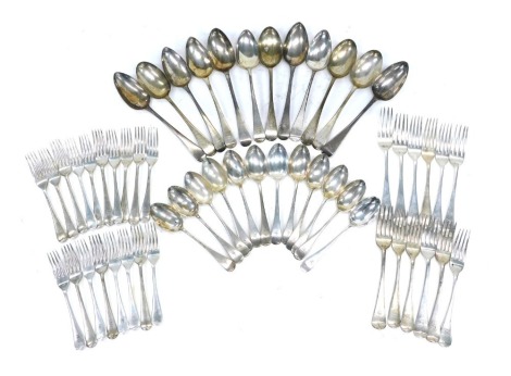 A composite old English pattern silver part canteen, various dates, each engraved the letter S, comprising eleven tablespoons, 24.14oz, twelve dessert spoons, 16.97oz, twelve table forks, 28.61oz, eighteen dessert forks, 27.18oz, 96.9oz gross weight..