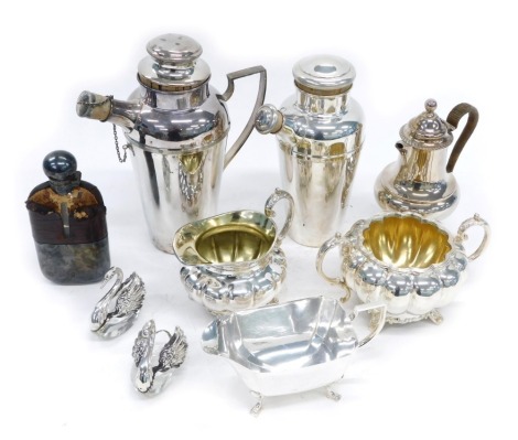 A group of silver plated wares, comprising two cocktail shakers, coffee pot, hip flask, milk jug, sugar bowl, swan preserve pots, etc.