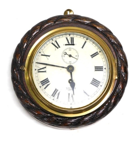 A Smiths Empire wall clock, the oak cased carved with rope twist, 21cm diameter.