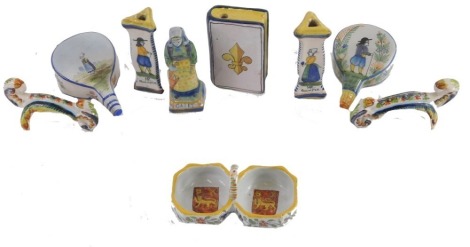 Various French Faience novelty items, to include a 19thC Quimper book shaped flask, two pairs of knife rests, figure, pair of bellow shaped wall pockets, and a double salt.