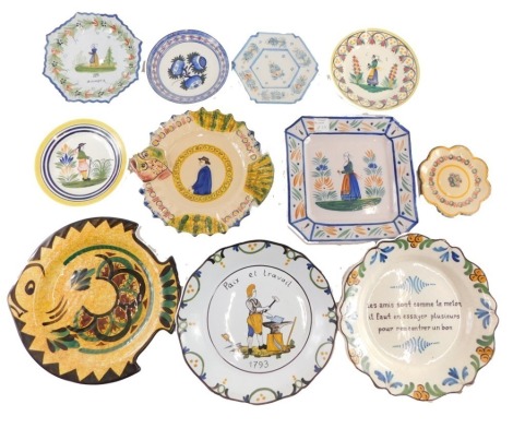 A quantity of Quimper and other Faience plates, to include two large fish shaped plates, etc.