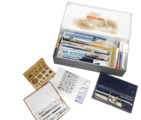 A quantity of drawing equipment, to include a set of drawing instruments, various stencils, a further drawing instrument, and a part set of weights.