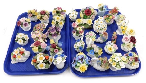 A large collection of Royal Doulton, Aynsley and other flower encrusted ornaments, or vases. (2 trays)