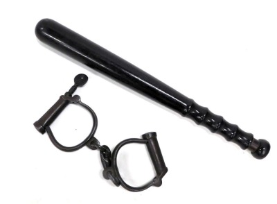 A turned hardwood policeman's truncheon, and a pair of iron handcuffs. (2)