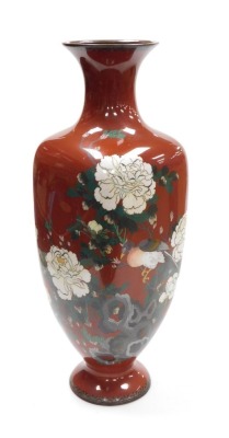 A Japanese Meiji period silver wire cloisonne vase, of shouldered square tapering form, decorated with birds and peonies on a red ground, 61.5cm high.