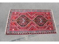 Three similar Persian design rugs each with central pole medallion on a red ground