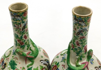 A pair of late 19thC Qing dynasty Cantonese famille rose pottery vases, of long necked bulbous form, moulded with chilin (baby dragons) and decorated with butterflies and flowers, 29cm high. - 5