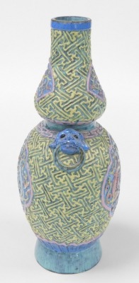 A 19thC Chinese porcelain double gourd vase, with lion dog and ring handles, decorated in relief with reserves of dragons, bats, and flowers, within a ground moulded with geometric lattice work, bears gilt six character Qianlong seal mark to base, 28cm hi - 2