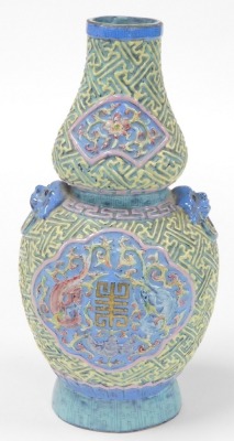 A 19thC Chinese porcelain double gourd vase, with lion dog and ring handles, decorated in relief with reserves of dragons, bats, and flowers, within a ground moulded with geometric lattice work, bears gilt six character Qianlong seal mark to base, 28cm hi - 3