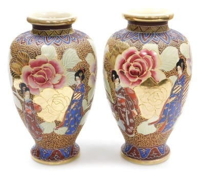 A pair of 20thC Japanese Satsuma vases, of baluster form, decorated with ladies in a garden with oversized flowers, on a brown ground, signed, 32cm high.