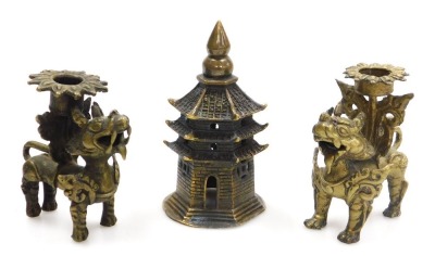 A group of Chinese brassware, including a pair of lion dog candlesticks, a dragon teapot, a four faces of Buddha bust paperweight, and figures of deities, together with a Tibetan figure of a seated Buddha, etc. (a quantity) - 5