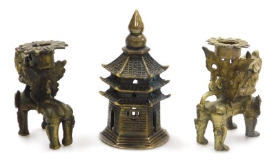 A group of Chinese brassware, including a pair of lion dog candlesticks, a dragon teapot, a four faces of Buddha bust paperweight, and figures of deities, together with a Tibetan figure of a seated Buddha, etc. (a quantity) - 6