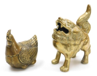 A group of Chinese brassware, including a pair of lion dog candlesticks, a dragon teapot, a four faces of Buddha bust paperweight, and figures of deities, together with a Tibetan figure of a seated Buddha, etc. (a quantity) - 8