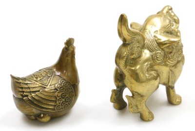 A group of Chinese brassware, including a pair of lion dog candlesticks, a dragon teapot, a four faces of Buddha bust paperweight, and figures of deities, together with a Tibetan figure of a seated Buddha, etc. (a quantity) - 9