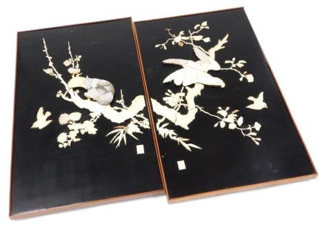 A pair of Japanese Meiji period black lacquer panels, worked in bone and mother of pearl, with birds and branches with blossom, bears rectangular seal, framed, 41cm x 36.5cm. (AF)