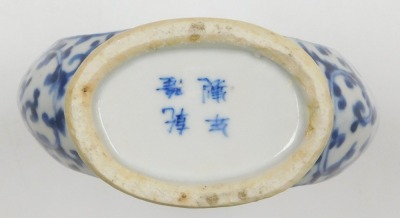 A Qing dynasty blue and white porcelain moon flask, decorated centrally with figures in a garden within a floral ground, Qianlong four character mark, 15cm high. - 6