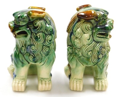 A pair of Chinese green glazed dogs of fo, modelled facing left and right in seated pose, 21cm wide. - 2