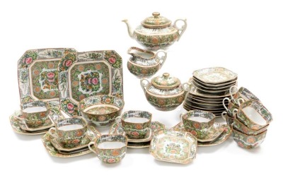 A 20thC Cantonese famille rose porcelain tea service, decorated with birds, butterflies and flowers, printed red China mark, comprising; teapot, sucrier, cream jug, sugar or slop bowl, pair of bread plates, eleven tea cups, nine saucers, and twelve tea pl