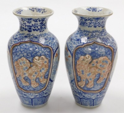 A pair of Meiji period Japanese blue and white vases, of shouldered, tapering form, decorated with reserve panels of relief decorated with shishi, interspersed with panels of birds and trees, on a blue and white floral and foliate ground, three character - 3