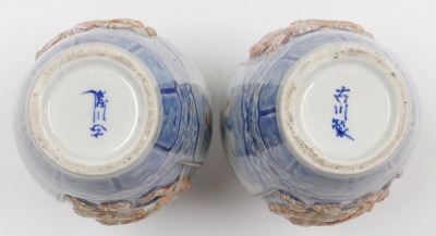 A pair of Meiji period Japanese blue and white vases, of shouldered, tapering form, decorated with reserve panels of relief decorated with shishi, interspersed with panels of birds and trees, on a blue and white floral and foliate ground, three character - 6